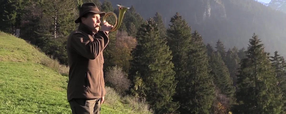 Austrian hunter blowing horn